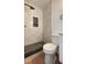 Bathroom featuring stylish shower with marble tile and modern fixtures at 331 N Dollins Ave, Orlando, FL 32805