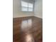 A sun-lit bedroom with beautiful hardwood floors and white trim at 331 N Dollins Ave, Orlando, FL 32805