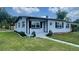 Charming single-story home with white paint, dark shutters and new landscaping at 331 N Dollins Ave, Orlando, FL 32805