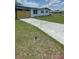 View of a house with a long driveway and manicured green lawn at 331 N Dollins Ave, Orlando, FL 32805