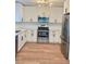 Modern kitchen with stainless steel appliances, white cabinets, and modern hardware at 331 N Dollins Ave, Orlando, FL 32805