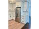 Bright kitchen with white cabinets, stainless steel refrigerator, and stylish hardware at 331 N Dollins Ave, Orlando, FL 32805