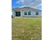 Expansive backyard featuring a covered patio and lush green grass at 33836 Sky Blossom Cir, Leesburg, FL 34788