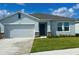 Charming single-story home with a two-car garage, well-manicured lawn and neutral paint at 33836 Sky Blossom Cir, Leesburg, FL 34788