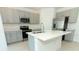 Stylish kitchen features stainless steel appliances, a center island, and gray cabinets at 33836 Sky Blossom Cir, Leesburg, FL 34788