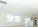 Open-concept living area leading to kitchen, filled with natural light from large windows at 33836 Sky Blossom Cir, Leesburg, FL 34788
