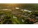 Scenic aerial view of community featuring lush landscapes, golf course, sand traps, water features, and beautiful homes at 3512 Legacy Hills Ct, Longwood, FL 32779