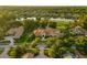 Expansive estate with meticulously landscaped grounds, tile roof, and a serene lake view at 3512 Legacy Hills Ct, Longwood, FL 32779