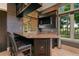 Convenient bar area with granite countertop, sink, and mounted television; great for entertaining guests in style at 3512 Legacy Hills Ct, Longwood, FL 32779