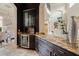 Stylish bar area with dark cabinetry, granite countertops, and a wine refrigerator at 3512 Legacy Hills Ct, Longwood, FL 32779