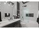 Modern bathroom with sleek black and white patterned walls and glass shower at 3512 Legacy Hills Ct, Longwood, FL 32779