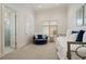 A cozy bedroom with a blue round chair, daybed, and ensuite bathroom at 3512 Legacy Hills Ct, Longwood, FL 32779