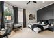 A stylish bedroom with a modern accent wall, plush bedding, and ample natural light at 3512 Legacy Hills Ct, Longwood, FL 32779