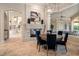 Elegant dining room features a fireplace, travertine floors, and a round wood table with upholstered chairs at 3512 Legacy Hills Ct, Longwood, FL 32779