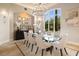 Elegant dining room with a glass table, seating for eight, and large windows at 3512 Legacy Hills Ct, Longwood, FL 32779
