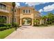 Beautiful Mediterranean style home with arched entrance, lush landscaping, and brick driveway at 3512 Legacy Hills Ct, Longwood, FL 32779