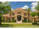 Elegant two-story home boasting a tile roof, arched entry, and well-maintained landscaping at 3512 Legacy Hills Ct, Longwood, FL 32779