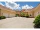 Stunning yellow home with a three-car garage, concrete driveway, and lush landscaping at 3512 Legacy Hills Ct, Longwood, FL 32779