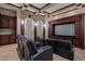 A custom home theater with wood cabinetry and tiered seating at 3512 Legacy Hills Ct, Longwood, FL 32779