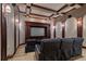 A luxurious home theater featuring tiered seating and custom wood trim at 3512 Legacy Hills Ct, Longwood, FL 32779