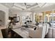 Open concept living area with ample seating, decorative rug, and access to the outdoor space at 3512 Legacy Hills Ct, Longwood, FL 32779