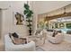 Bright living room featuring high ceilings, modern decor, and a view of the outdoor pool area at 3512 Legacy Hills Ct, Longwood, FL 32779