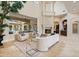 Bright living room with travertine floors, fireplace, and a view of the pool at 3512 Legacy Hills Ct, Longwood, FL 32779