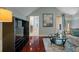 Stylish living room with dark wood floors, a large TV, and natural light at 3512 Legacy Hills Ct, Longwood, FL 32779
