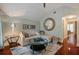 Comfortable living room with a plush sofa, round mirror, and an inviting atmosphere at 3512 Legacy Hills Ct, Longwood, FL 32779