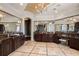 Elegant bathroom showcasing dual vanities with granite countertops and decorative mirrors, complemented by stylish tile flooring at 3512 Legacy Hills Ct, Longwood, FL 32779