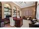 Cozy office with built-in shelving, comfortable seating, a desk, and warm lighting at 3512 Legacy Hills Ct, Longwood, FL 32779
