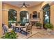 Inviting outdoor patio with a fireplace, comfortable seating, and views of lush greenery for relaxed entertaining at 3512 Legacy Hills Ct, Longwood, FL 32779