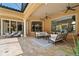 Spacious covered patio with travertine tile, ceiling fans, and plenty of seating at 3512 Legacy Hills Ct, Longwood, FL 32779