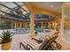 The outdoor patio with lounge chairs overlooks the stunning pool and spa area, perfect for relaxation and entertainment at 3512 Legacy Hills Ct, Longwood, FL 32779