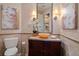 Chic powder room featuring decorative wallpaper, sink basin, and modern toilet at 3512 Legacy Hills Ct, Longwood, FL 32779
