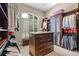 Spacious walk-in closet with custom shelving, drawers, and ample storage, perfect for organizing wardrobe and accessories at 3512 Legacy Hills Ct, Longwood, FL 32779