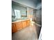 Bright bathroom featuring double glass vessel sinks, a tile shower, and a neutral color palette at 3549 Wilshire Way Rd # 56, Orlando, FL 32829