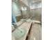 Bright bathroom featuring double glass vessel sinks, a tile shower, and a neutral color palette at 3549 Wilshire Way Rd # 56, Orlando, FL 32829