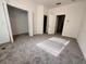 Bright bedroom featuring neutral carpet, natural light from the window, and multiple closets at 3549 Wilshire Way Rd # 56, Orlando, FL 32829