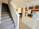 Bright entryway featuring a staircase and an open view into the kitchen with tile flooring at 3549 Wilshire Way Rd # 56, Orlando, FL 32829
