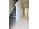 Open entryway featuring a carpeted staircase and tile flooring leading towards natural light at 3549 Wilshire Way Rd # 56, Orlando, FL 32829