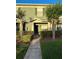 Charming townhome featuring a well-manicured lawn, lush shrubs, and a welcoming entrance at 3549 Wilshire Way Rd # 56, Orlando, FL 32829