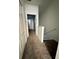 Hallway with carpet and closet doors leading to stairs and other rooms at 3549 Wilshire Way Rd # 56, Orlando, FL 32829
