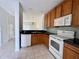 Functional kitchen featuring wooden cabinets, granite counters, and modern appliances with an open layout at 3549 Wilshire Way Rd # 56, Orlando, FL 32829