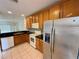 Efficient kitchen showcasing ample cabinetry, modern appliances, and black countertops on tile flooring at 3549 Wilshire Way Rd # 56, Orlando, FL 32829