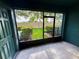 Screened patio with green paint offers a view of the fenced backyard and lush landscaping at 3549 Wilshire Way Rd # 56, Orlando, FL 32829