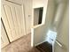 Staircase with carpet runner and white trim, leading to the upper level with a bedroom visible at 3549 Wilshire Way Rd # 56, Orlando, FL 32829