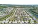 Expansive aerial view of a suburban neighborhood with well-manicured lawns, mature trees, and picturesque waterways at 4737 Maple Park St, Orlando, FL 32811