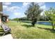 Backyard with lush green lawn and scenic waterfront view, offering serene outdoor relaxation at 4737 Maple Park St, Orlando, FL 32811
