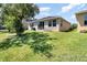 Spacious backyard with lush green lawn and patio seating, perfect for outdoor relaxation and enjoyment at 4737 Maple Park St, Orlando, FL 32811